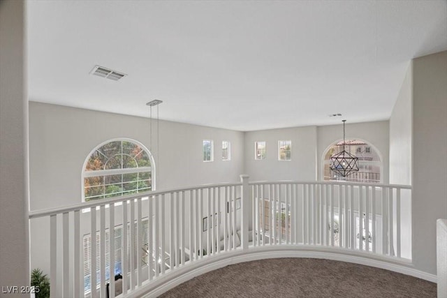 7012 Geese Gathering St, North Las Vegas, NV 89084 - corridor with a chandelier and carpet floors