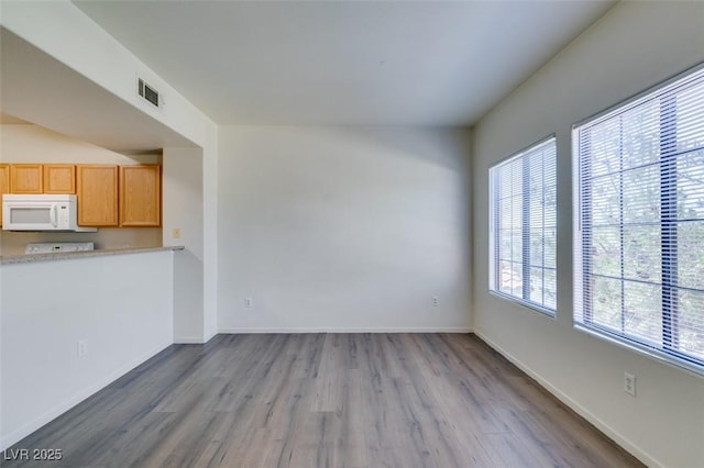 2030 Rancho Lake Dr Unit 201, Las Vegas, NV 89108 - unfurnished living room with wood finished floors and baseboards
