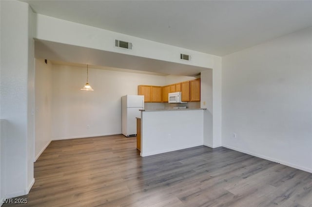 2030 Rancho Lake Dr Unit 201, Las Vegas, NV 89108 - kitchen featuring white appliances, wood finished floors, a peninsula, and open floor plan