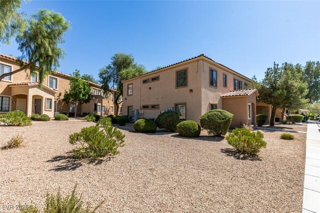 2030 Rancho Lake Dr Unit 201, Las Vegas, NV 89108 - view of side of property with stucco siding, a residential view, and a tile roof