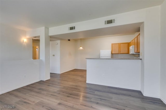 2030 Rancho Lake Dr Unit 201, Las Vegas, NV 89108 - unfurnished living room featuring wood finished floors and baseboards