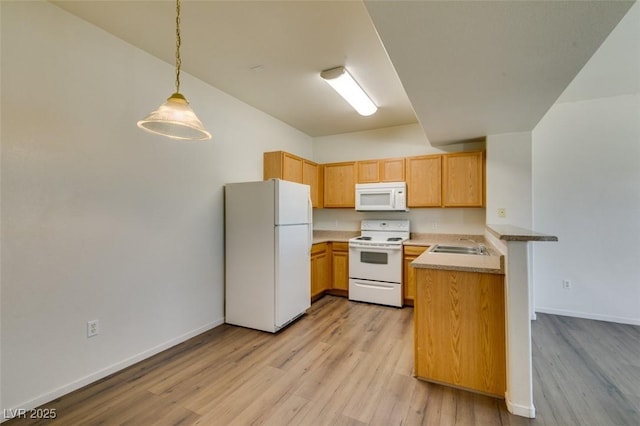 2030 Rancho Lake Dr Unit 201, Las Vegas, NV 89108 - kitchen with white appliances, a peninsula, light wood-style flooring, decorative light fixtures, and light countertops
