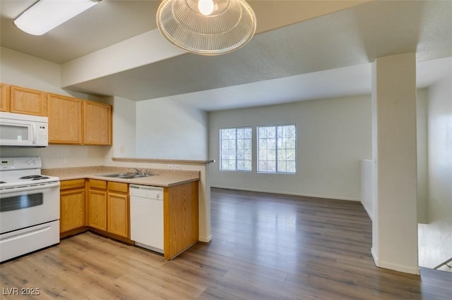 2030 Rancho Lake Dr Unit 201, Las Vegas, NV 89108 - kitchen with white appliances, a peninsula, open floor plan, and light wood-style flooring