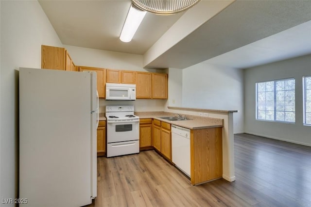 2030 Rancho Lake Dr Unit 201, Las Vegas, NV 89108 - kitchen with white appliances, a peninsula, light wood finished floors, light countertops, and open floor plan