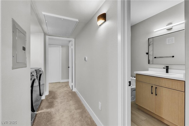 5710 E Tropicana Ave Unit 2152, Las Vegas, NV 89122 - corridor featuring attic access, electric panel, independent washer and dryer, and light colored carpet