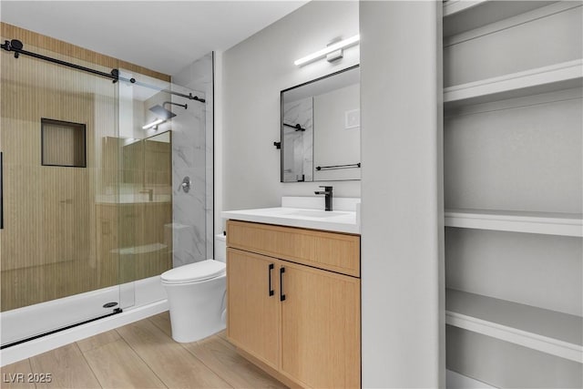 5710 E Tropicana Ave Unit 2152, Las Vegas, NV 89122 - full bath featuring a shower stall, vanity, and wood finished floors