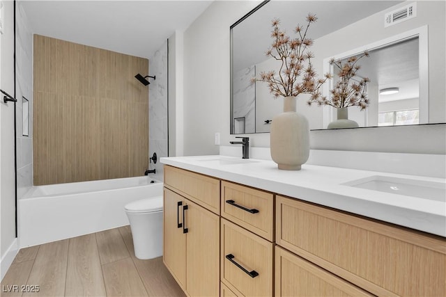 5710 E Tropicana Ave Unit 2152, Las Vegas, NV 89122 - full bathroom with double vanity, wood finished floors, and bathing tub / shower combination