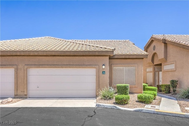 4770 Big Draw Dr, North Las Vegas, NV 89031 - view of front of house with a tiled roof, an attached garage, concrete driveway, and stucco siding