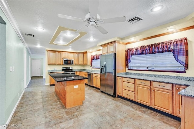 1885 Valley Dr, Las Vegas, NV 89108 - kitchen with appliances with stainless steel finishes, crown molding, a kitchen island, ceiling fan, and light brown cabinets