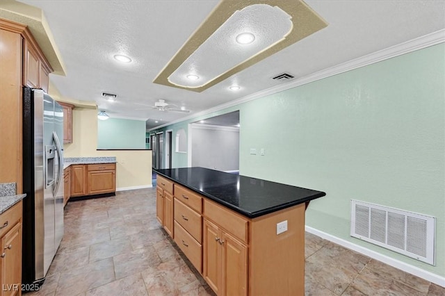 1885 Valley Dr, Las Vegas, NV 89108 - kitchen with stainless steel fridge with ice dispenser, crown molding, a center island, ceiling fan, and a textured ceiling