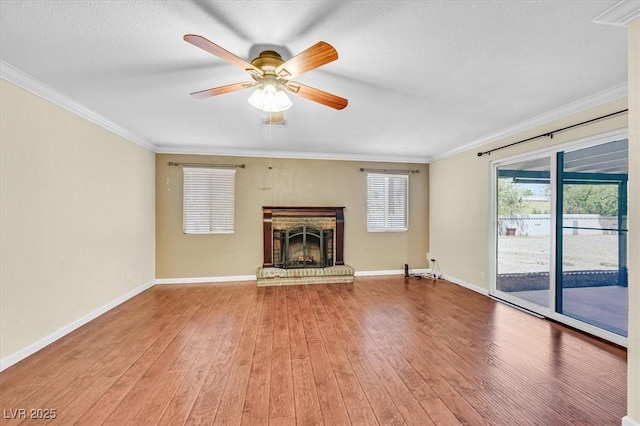 1885 Valley Dr, Las Vegas, NV 89108 - unfurnished living room with a ceiling fan, ornamental molding, wood finished floors, a brick fireplace, and a textured ceiling