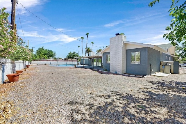1885 Valley Dr, Las Vegas, NV 89108 - rear view of house featuring a chimney and stucco siding