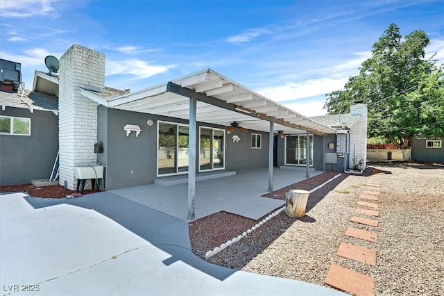 1885 Valley Dr, Las Vegas, NV 89108 - rear view of property featuring a chimney, ceiling fan, a patio, and stucco siding