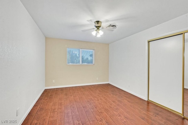 1885 Valley Dr, Las Vegas, NV 89108 - unfurnished bedroom featuring wood finished floors, a closet, and ceiling fan