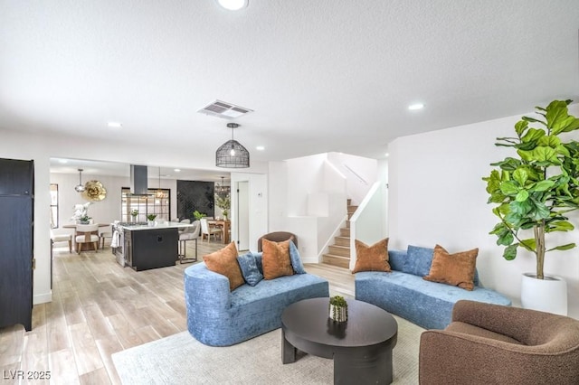 10009 Coral Sands Dr, Las Vegas, NV 89117 - living room featuring light wood-type flooring, stairway, and recessed lighting