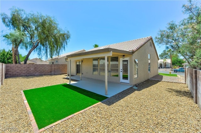 3622 Covewick Dr, North Las Vegas, NV 89032 - rear view of house featuring a fenced backyard, a tile roof, stucco siding, and a patio area
