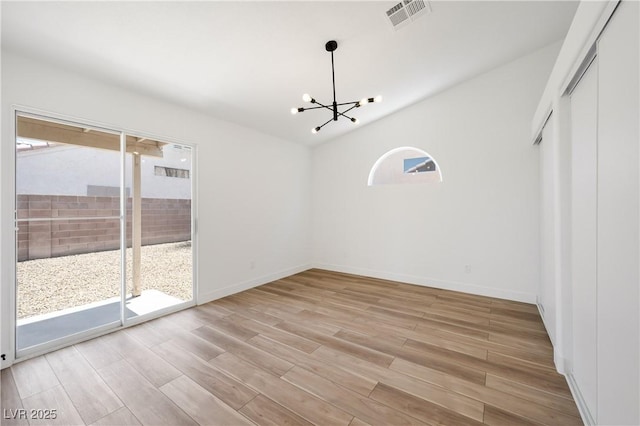 3622 Covewick Dr, North Las Vegas, NV 89032 - unfurnished dining area featuring healthy amount of natural light, a chandelier, light wood-style floors, and lofted ceiling