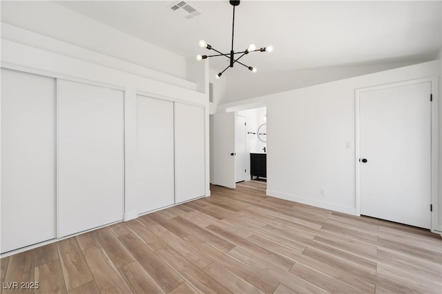 3622 Covewick Dr, North Las Vegas, NV 89032 - unfurnished bedroom featuring a chandelier, multiple closets, light wood-type flooring, lofted ceiling, and ensuite bathroom