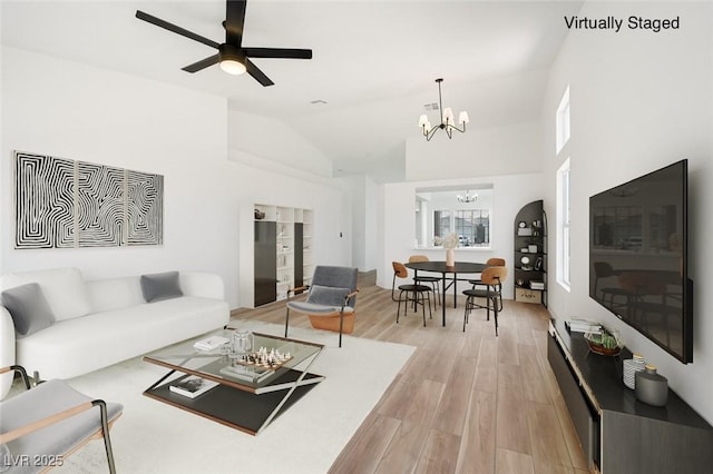 3622 Covewick Dr, North Las Vegas, NV 89032 - living area with a chandelier, light wood-style floors, vaulted ceiling, and a ceiling fan