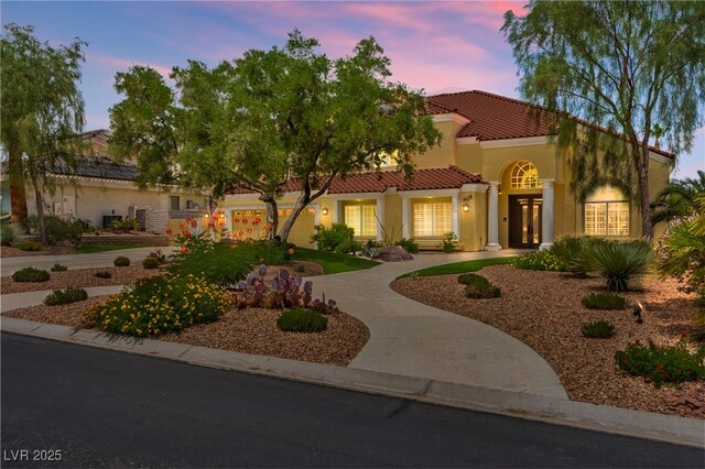 7428 Doe Ave, Las Vegas, NV 89117 - mediterranean / spanish house with a tiled roof, stucco siding, and french doors