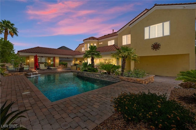 7428 Doe Ave, Las Vegas, NV 89117 - pool at dusk with a patio and an outdoor pool