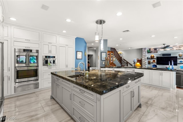 7428 Doe Ave, Las Vegas, NV 89117 - kitchen featuring a warming drawer, double oven, recessed lighting, open floor plan, and an island with sink
