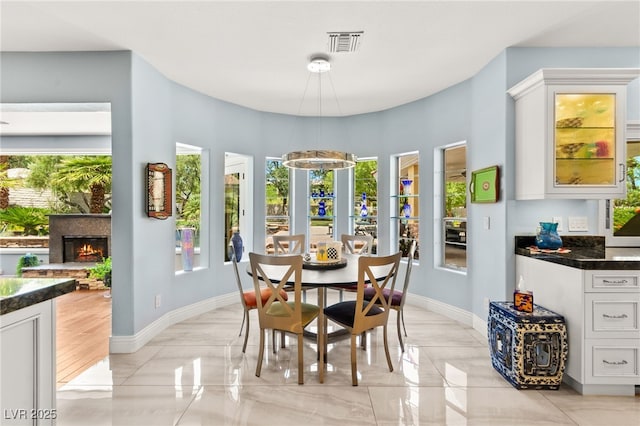 7428 Doe Ave, Las Vegas, NV 89117 - dining area with healthy amount of natural light and a glass covered fireplace