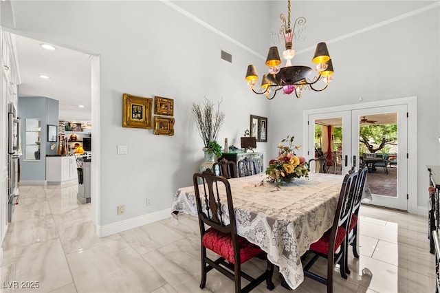 7428 Doe Ave, Las Vegas, NV 89117 - dining area featuring a chandelier, a high ceiling, french doors, recessed lighting, and light marble finish flooring