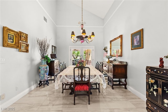 7428 Doe Ave, Las Vegas, NV 89117 - dining room featuring a chandelier, marble look tiles, and high vaulted ceiling