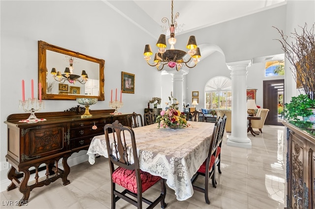 7428 Doe Ave, Las Vegas, NV 89117 - dining room featuring ornate columns, a towering ceiling, and a chandelier