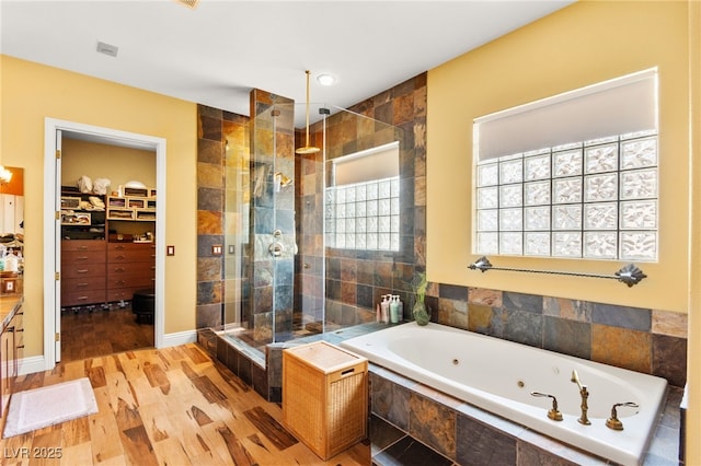 7428 Doe Ave, Las Vegas, NV 89117 - full bathroom with a shower stall, a tub with jets, wood finished floors, and a spacious closet