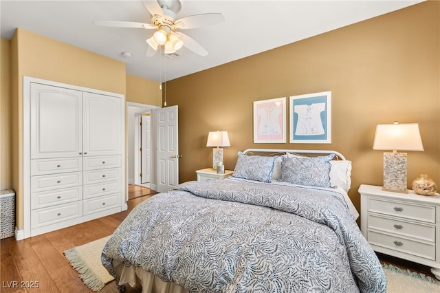 7428 Doe Ave, Las Vegas, NV 89117 - bedroom with wood finished floors, a closet, and a ceiling fan