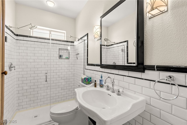 7428 Doe Ave, Las Vegas, NV 89117 - full bathroom with a shower stall, tile walls, and wainscoting