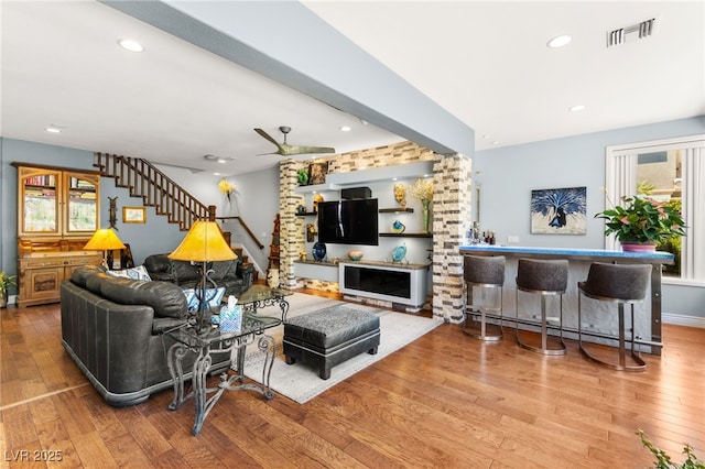 7428 Doe Ave, Las Vegas, NV 89117 - living area with a baseboard heating unit, hardwood / wood-style flooring, ceiling fan, stairs, and recessed lighting