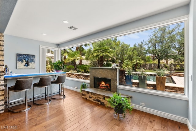7428 Doe Ave, Las Vegas, NV 89117 - interior space with wood-type flooring, baseboard heating, a warm lit fireplace, and recessed lighting