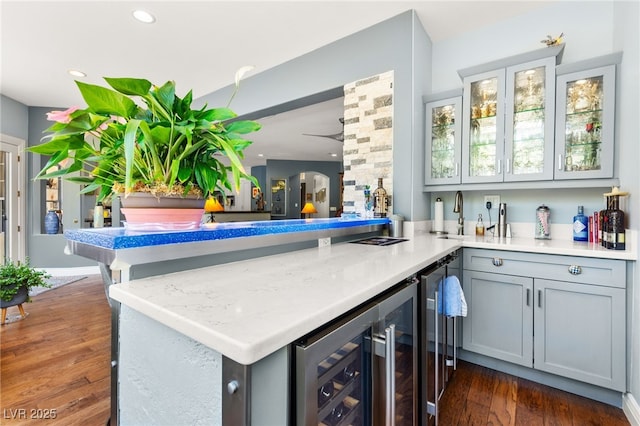 7428 Doe Ave, Las Vegas, NV 89117 - indoor wet bar featuring beverage cooler, dark wood-style floors, and recessed lighting