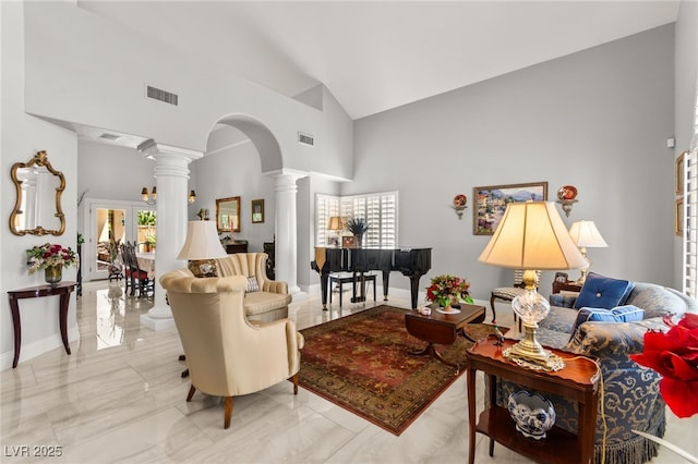 7428 Doe Ave, Las Vegas, NV 89117 - living room featuring ornate columns, arched walkways, high vaulted ceiling, and marble finish floors