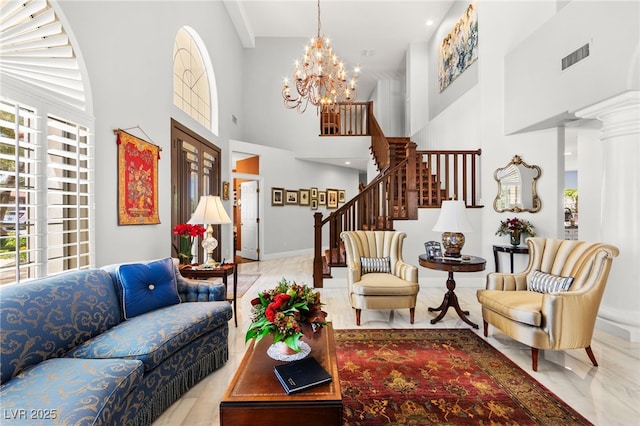 7428 Doe Ave, Las Vegas, NV 89117 - living room with a chandelier, a high ceiling, stairway, and marble finish flooring