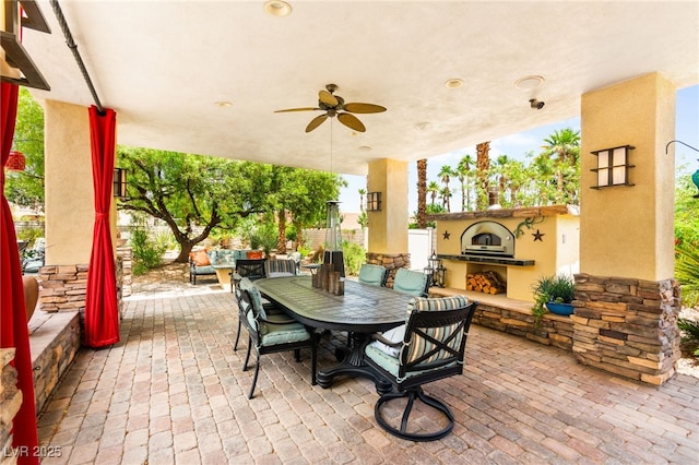 7428 Doe Ave, Las Vegas, NV 89117 - view of patio featuring ceiling fan, outdoor dining area, and an outdoor living space with a fireplace