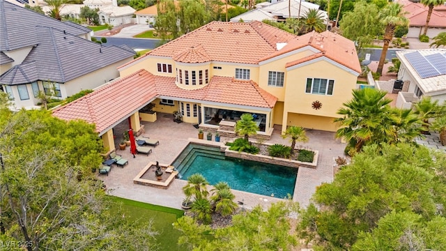 7428 Doe Ave, Las Vegas, NV 89117 - back of house with a tile roof, stucco siding, an outdoor living space with a fire pit, area for grilling, and an outdoor pool