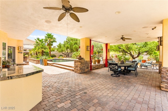 7428 Doe Ave, Las Vegas, NV 89117 - view of patio / terrace featuring ceiling fan, an outdoor kitchen, outdoor dining area, and an outdoor pool