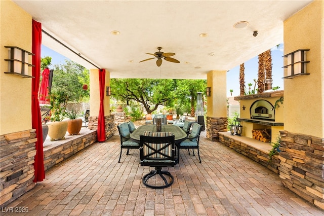 7428 Doe Ave, Las Vegas, NV 89117 - view of patio featuring outdoor dining space, a ceiling fan, and exterior fireplace
