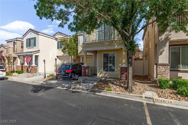1739 Spanish Sky Ave, Las Vegas, NV 89183 - townhome / multi-family property featuring a balcony, stucco siding, an attached garage, and driveway