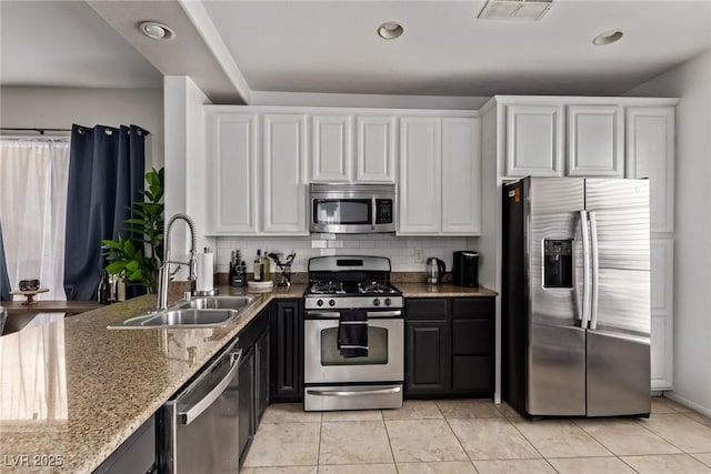 1739 Spanish Sky Ave, Las Vegas, NV 89183 - kitchen featuring appliances with stainless steel finishes, white cabinetry, decorative backsplash, light stone counters, and recessed lighting