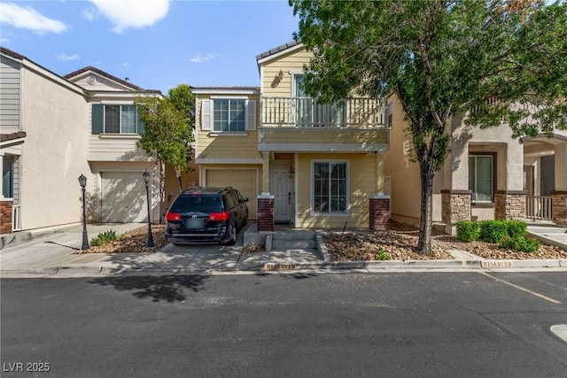 1739 Spanish Sky Ave, Las Vegas, NV 89183 - townhome / multi-family property with a balcony, an attached garage, driveway, and stucco siding