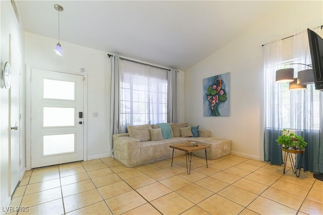 3650 Russian Olive St, North Las Vegas, NV 89032 - living area with light tile patterned flooring, vaulted ceiling, and plenty of natural light