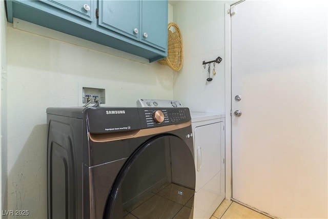 3650 Russian Olive St, North Las Vegas, NV 89032 - washroom with cabinet space, light tile patterned floors, and washer and dryer