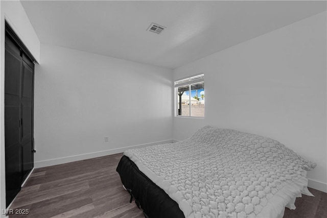 6129 Bedrock Ct, North Las Vegas, NV 89031 - bedroom featuring dark wood finished floors and a barn door