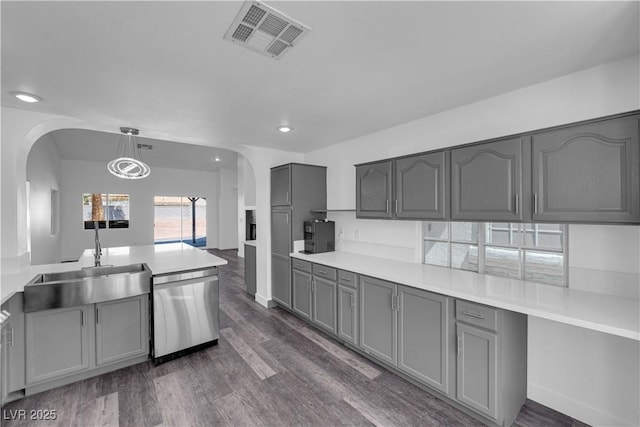 6129 Bedrock Ct, North Las Vegas, NV 89031 - kitchen with dishwasher, gray cabinets, arched walkways, light countertops, and recessed lighting