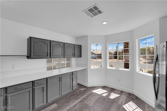 6129 Bedrock Ct, North Las Vegas, NV 89031 - kitchen featuring freestanding refrigerator, gray cabinetry, dark wood-style floors, light countertops, and recessed lighting
